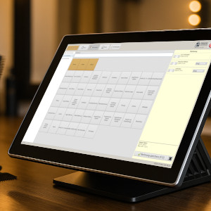 Ein modernes POS-Gerät mir der Software Friseur-Registrierkasse auf einem Friseurtisch.